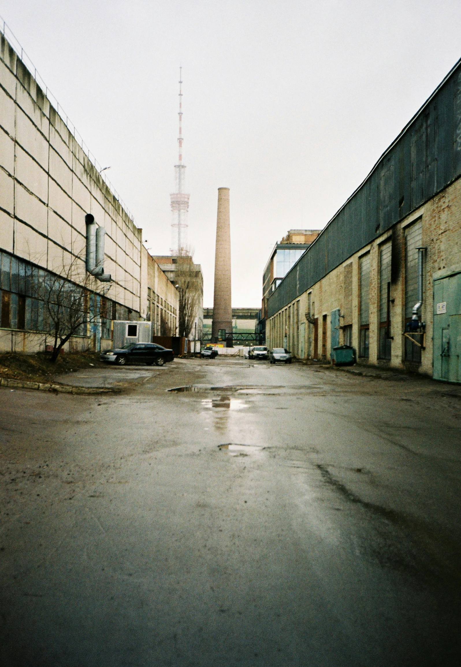 an empty street with tall buildings and towers