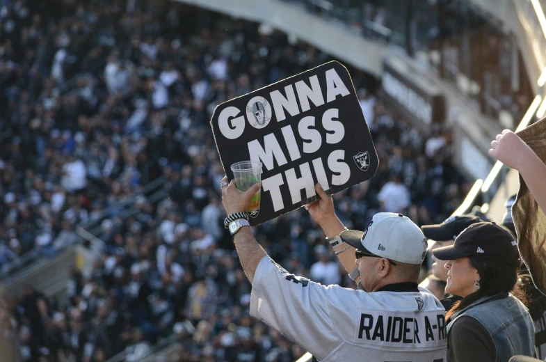 people are standing in the stands holding up signs