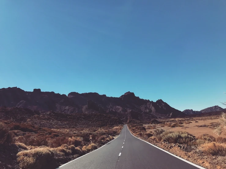 a road winding into the distance on a bright, clear day