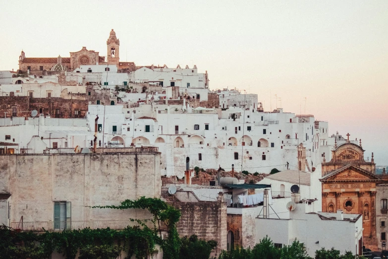 a number of buildings on a hill with a clock tower