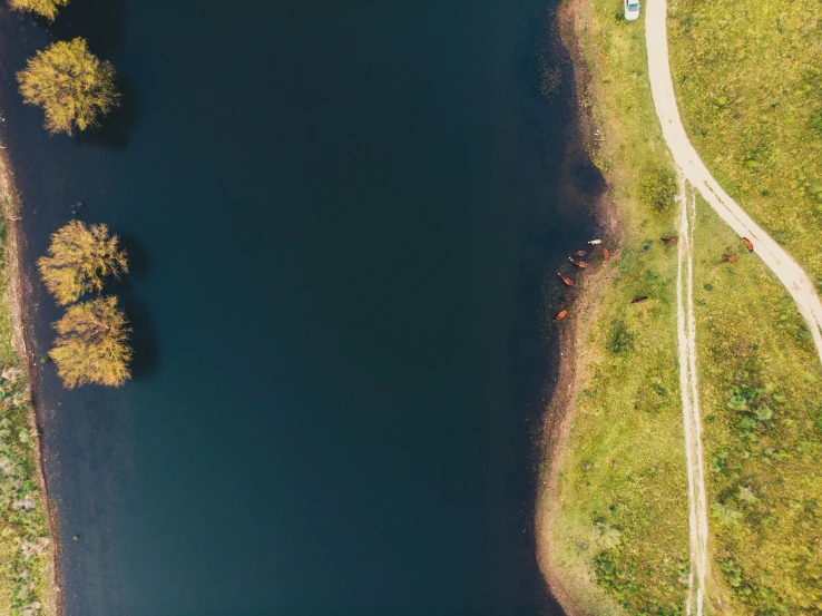 aerial view of road winding into an empty lake