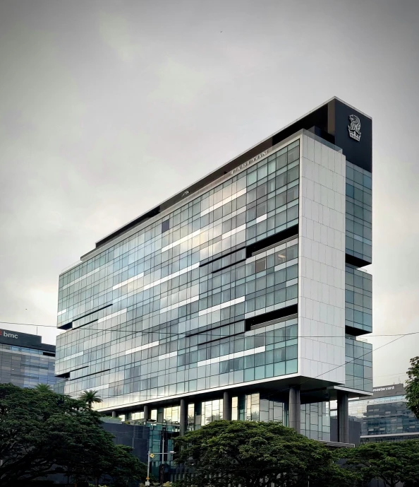 an office building with a gray facade and sky background