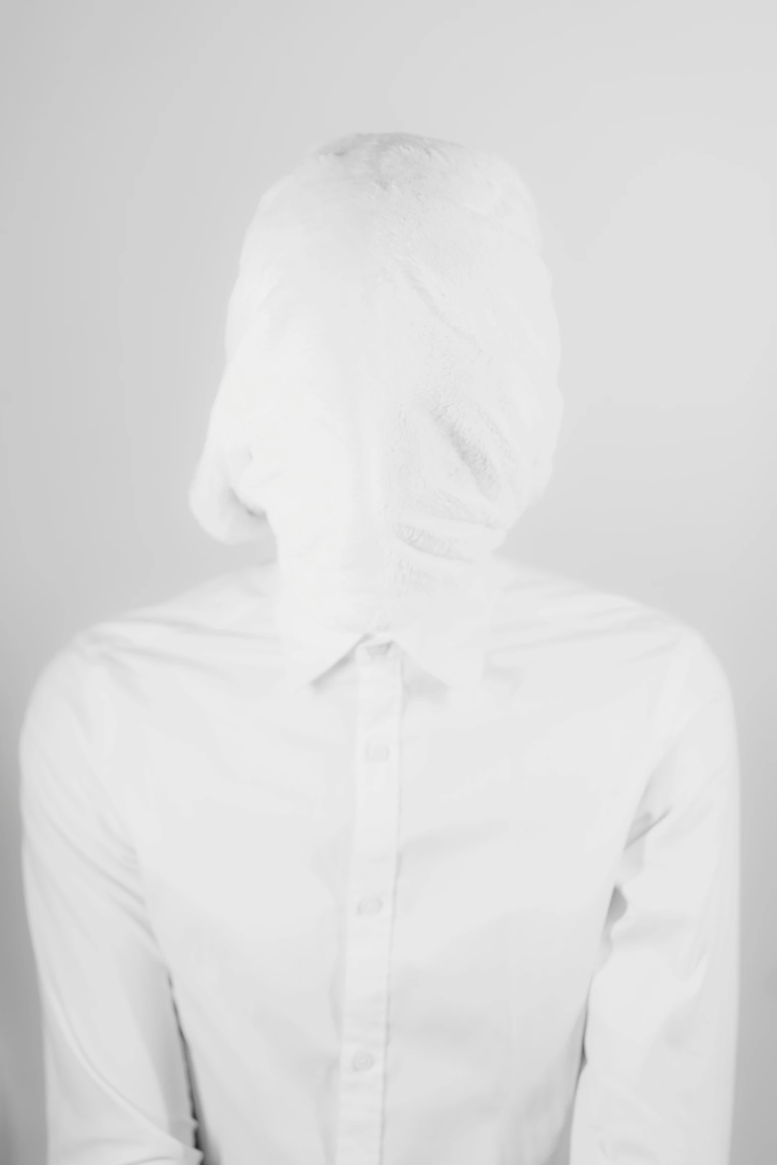 a person in a white blouse is seen from behind