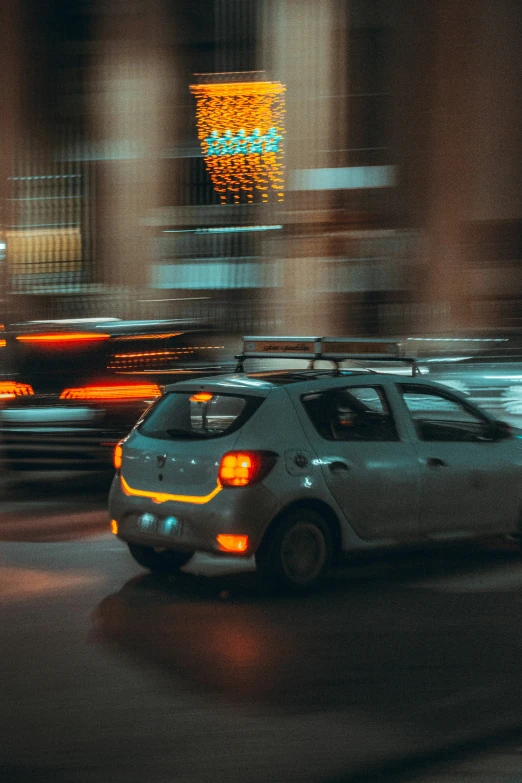 the rear view of a car speeding by a city street