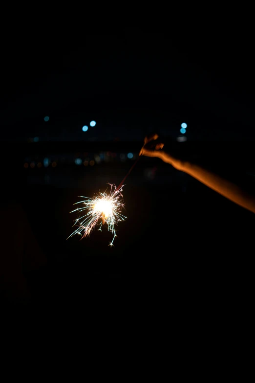 fireworks is being lit up over a nighttime landscape