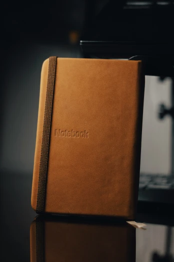 a leather notebook with the word i love book written on it