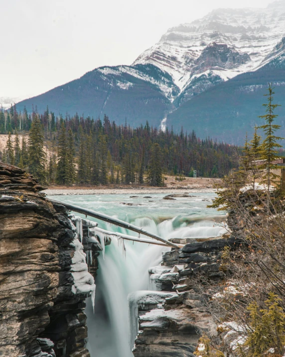 a waterfall is frozen at the bottom of a river