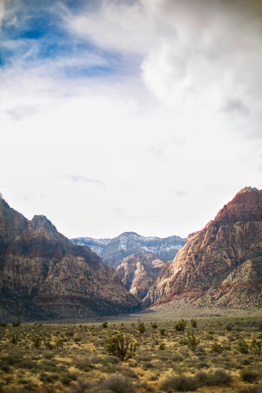 a wide view of mountains and desert with brown grass