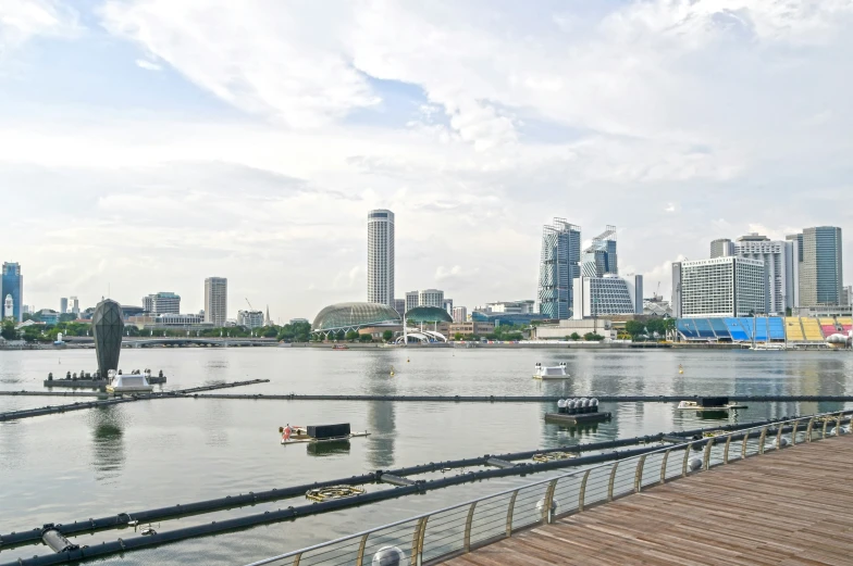 a city is seen over water by the boardwalk