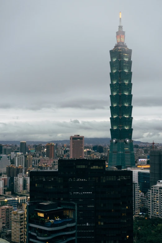 the very tall building is next to a very big city