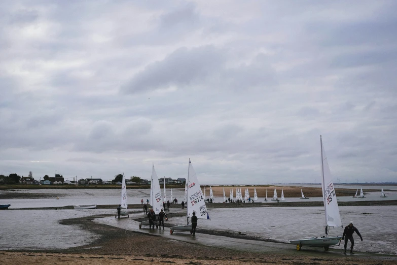 people on boats at the water during a cloudy day