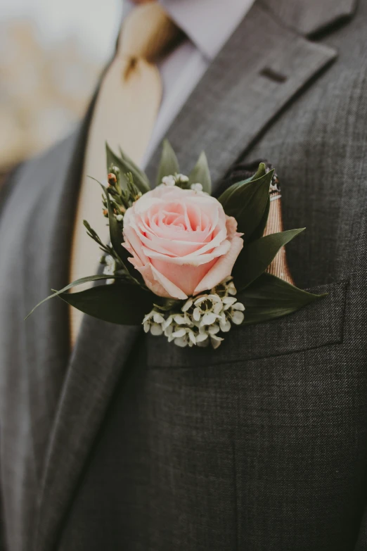 a man is in a suit with his boutonniere on