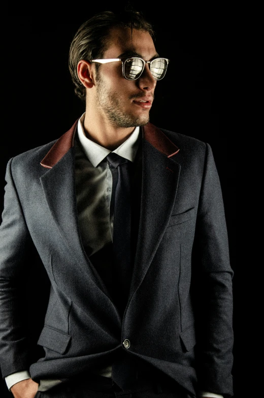 a man in a dark suit wearing sunglasses