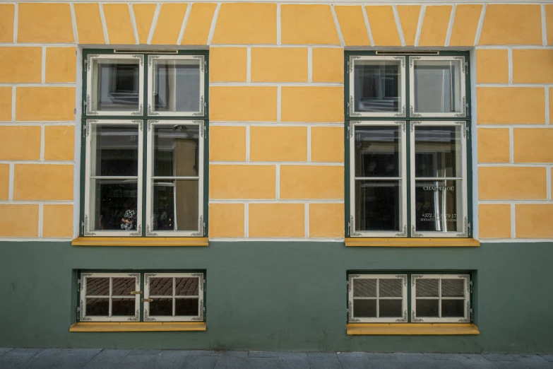 a building with two windows and a bicycle in the middle