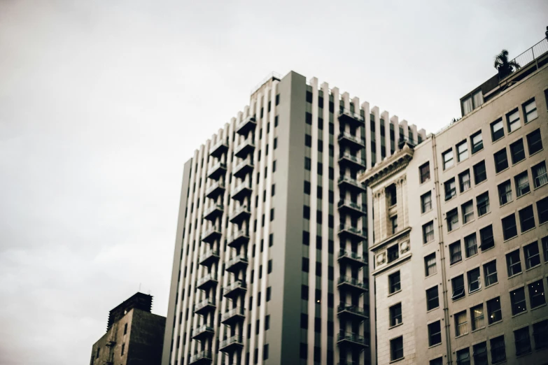 three buildings with very large windows against the sky