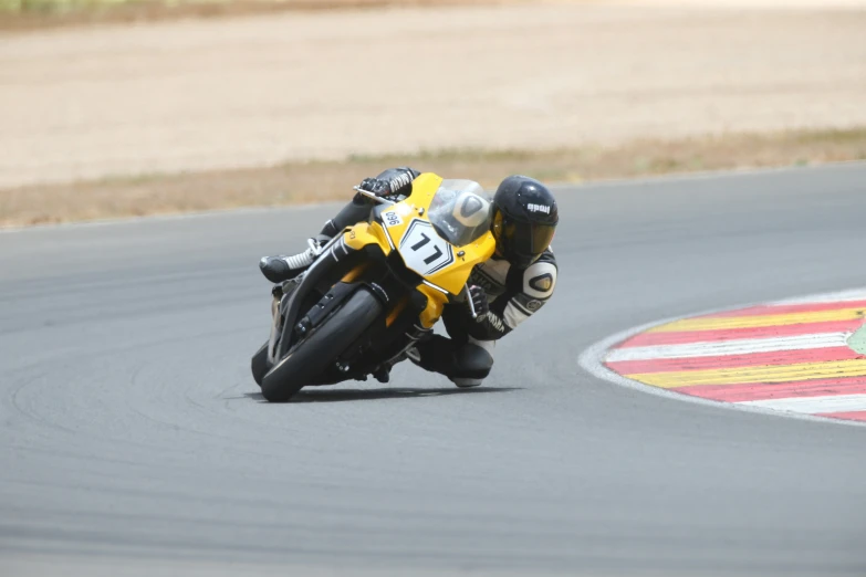 a person riding on a racing motorcycle on a race track