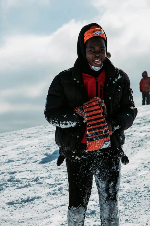 man wearing winter clothes while holding his snow board