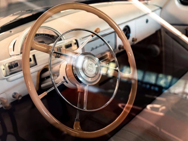 an old car dashboard with wooden steering wheel and wood accents