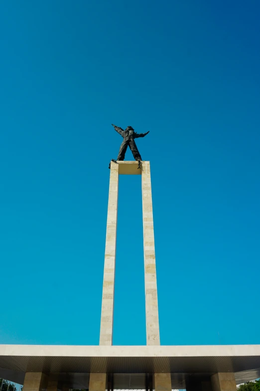 a person is standing on top of a column