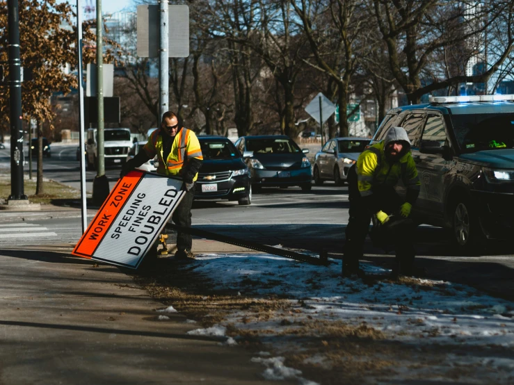 two police officers working on removing and cleaning the street