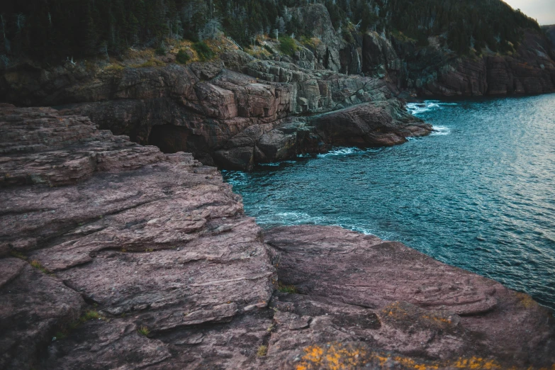 there is a large body of water on the side of rocks