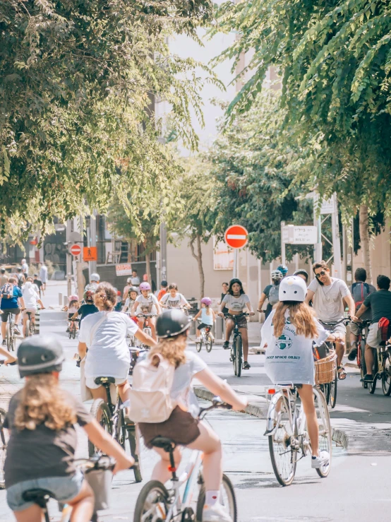 there are many people riding bikes and some on the street