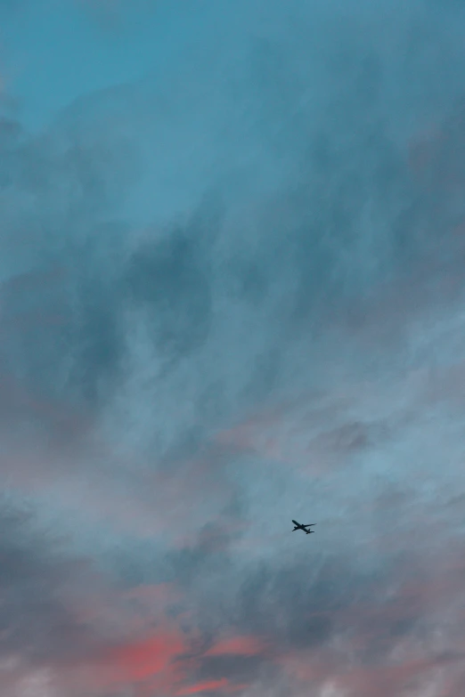 a plane flying in the air over a street