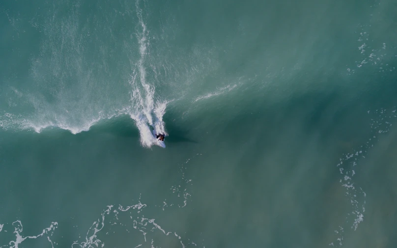 person surfing an ocean wave in the daytime