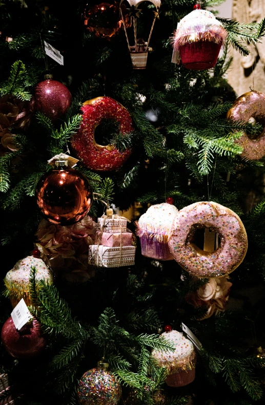 a very colorful christmas tree decorated with different ornaments