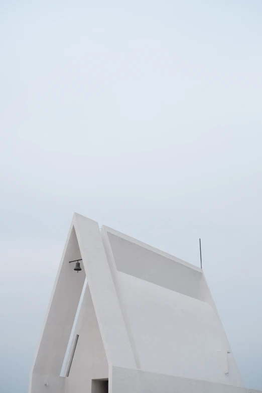 the architecture is white and has triangular shaped windows