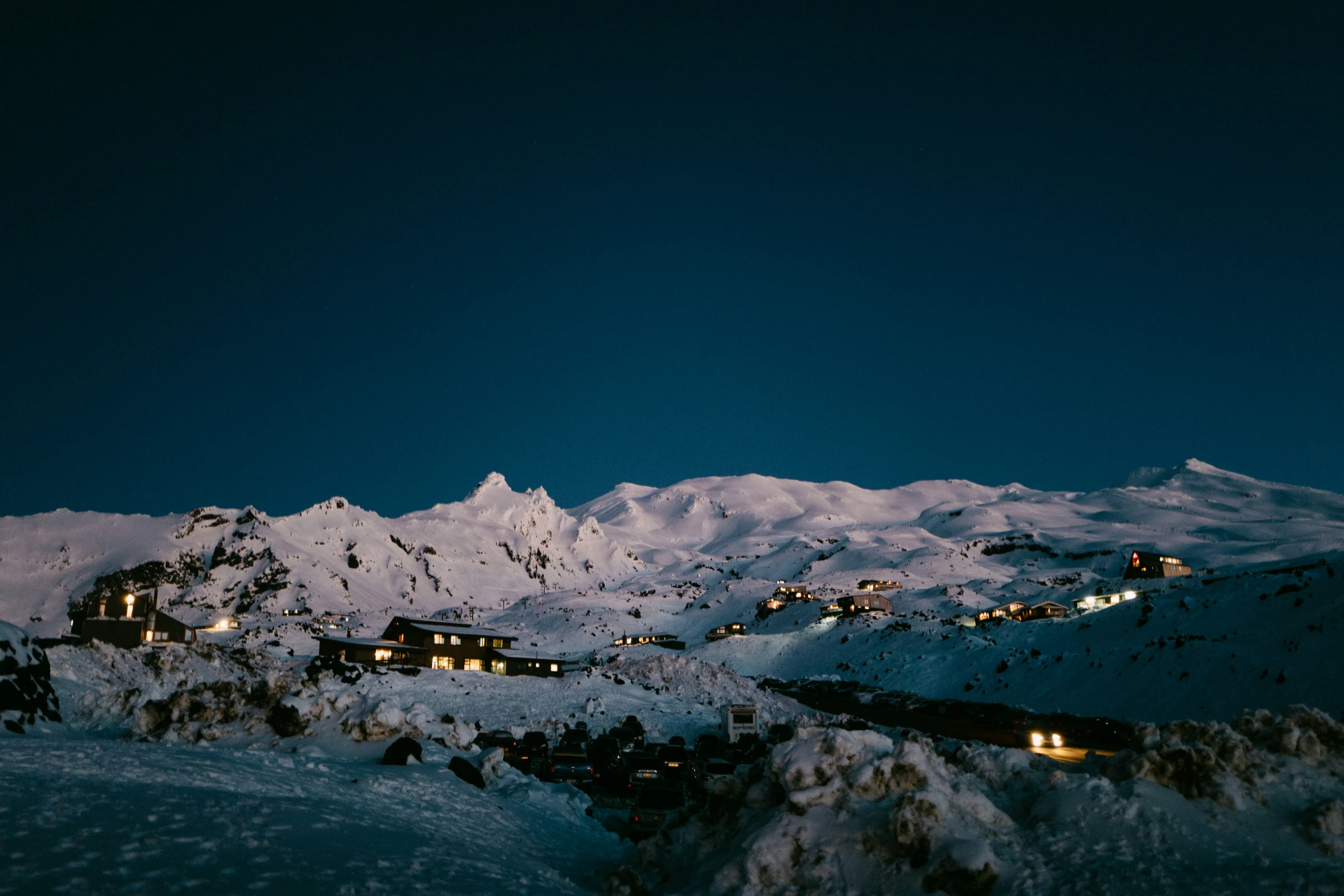 a mountain covered in snow under a night sky