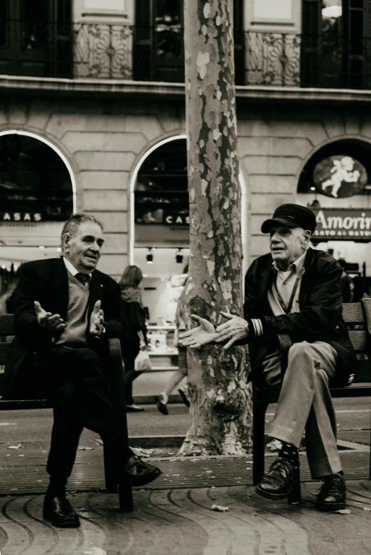 two older men sitting next to each other on a bench