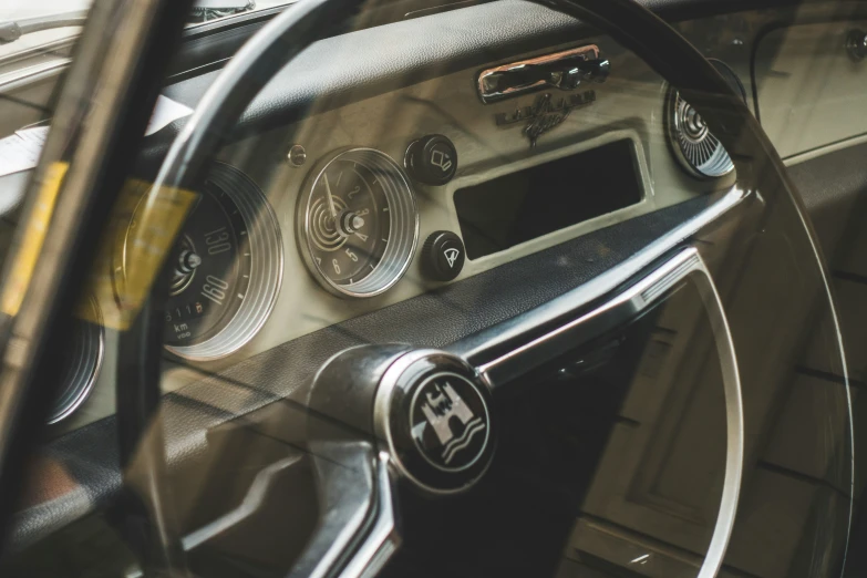 the inside view of an automobile with a steering wheel