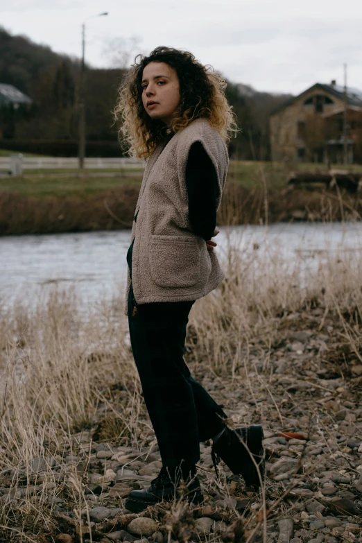 a young woman posing for a po by the river