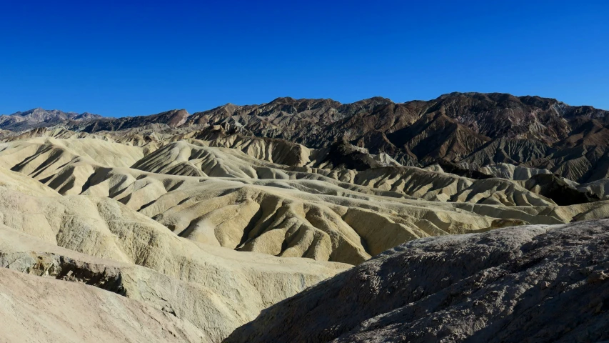 high altitude mountain range in the desert with a sky background