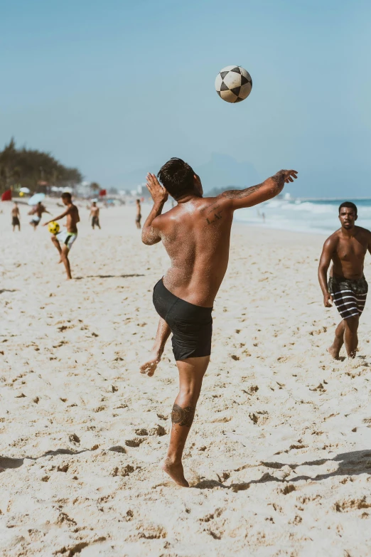 a man is throwing a soccer ball into the air