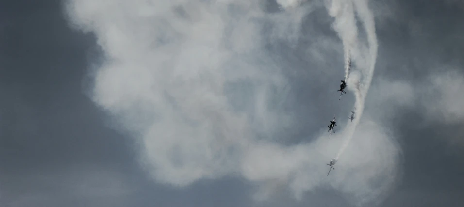 three planes flying in formation in a cloudy sky