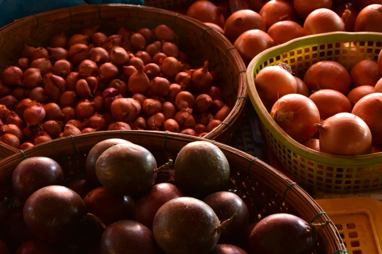 an assortment of fruit in baskets in a market