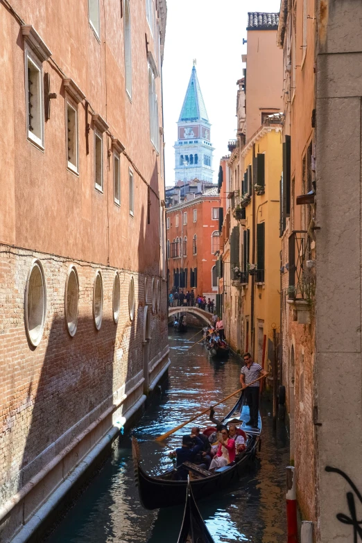 a small boat with passengers traveling down a canal