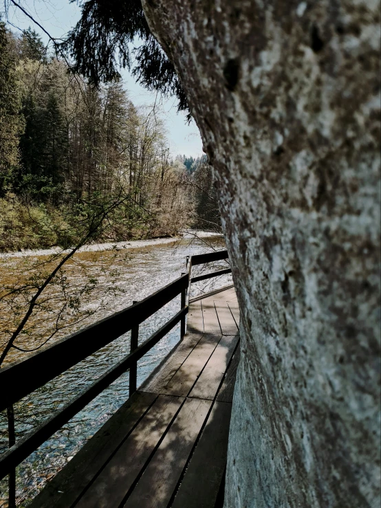 a wooden walkway near the edge of the river
