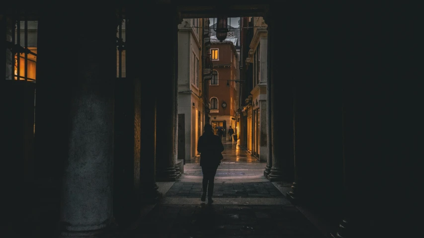 the person is walking down an alley way