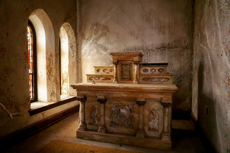 a church's alter with two windows that reflect sunlight