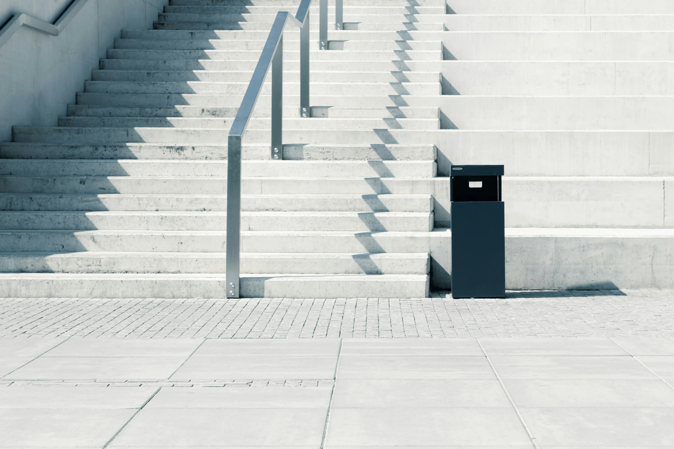 a metal hand rail next to a staircase