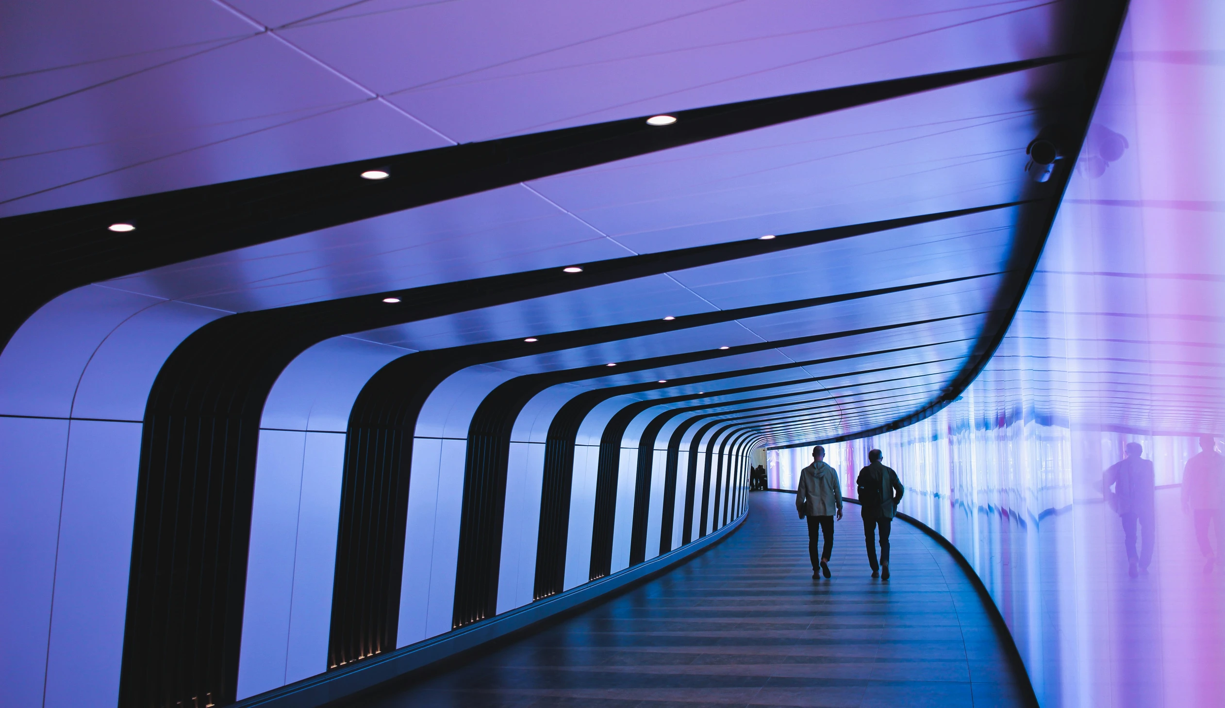 a long tunnel with people walking on it