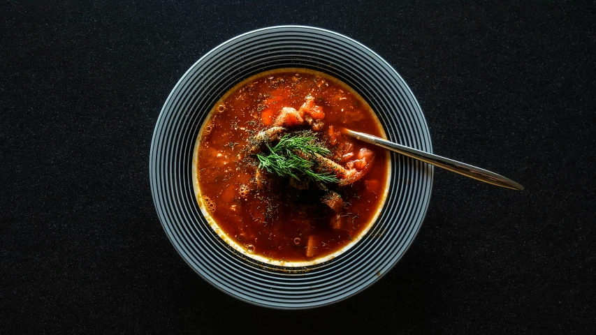 a bowl of soup with meat and vegetables