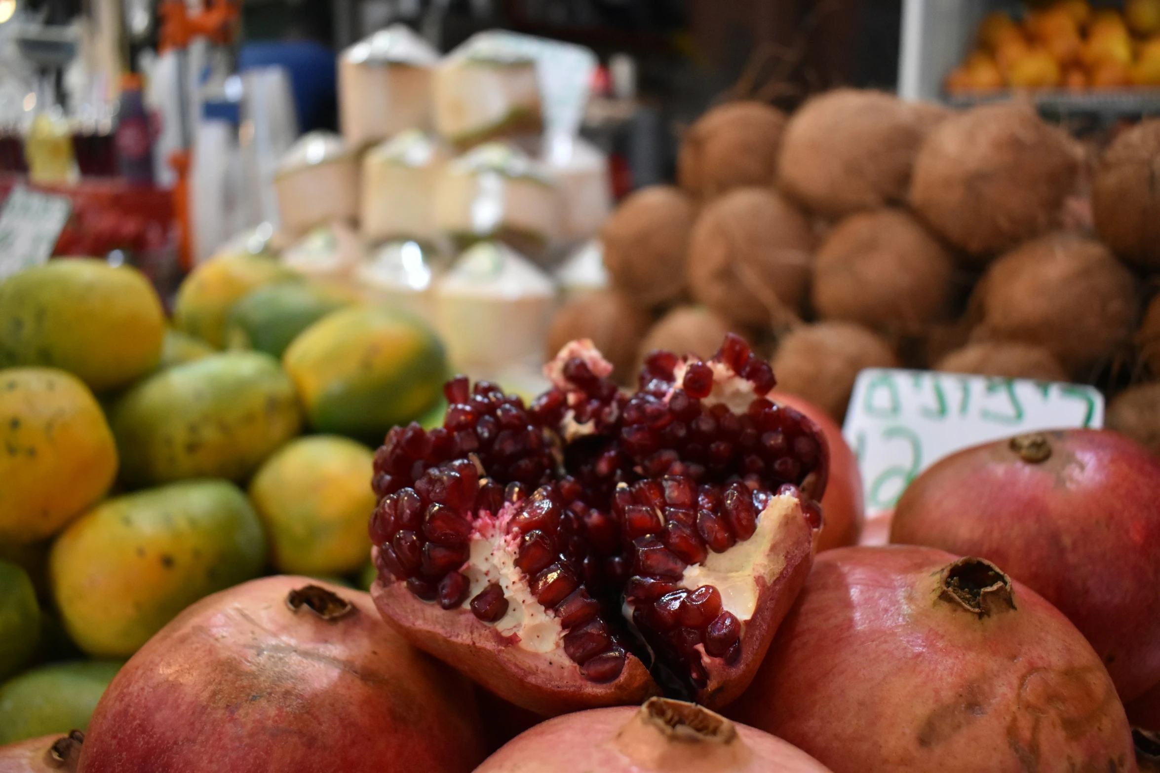 a view of a pile of pomegranates and two more pomegranates