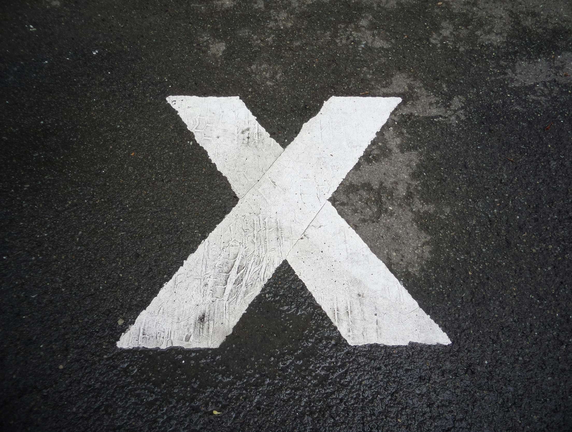 an image of an outside directional sign painted on the street