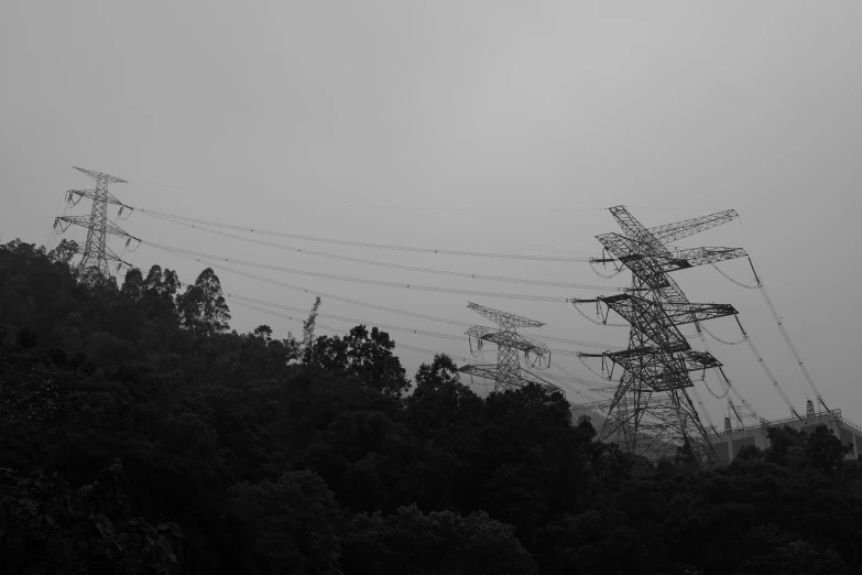 a number of power lines and towers on a hill