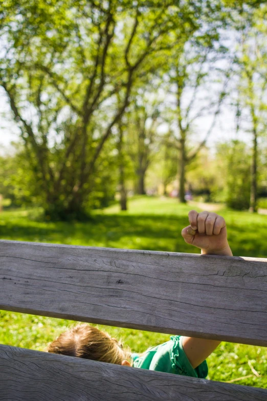 a boy on a bench is looking at his dad