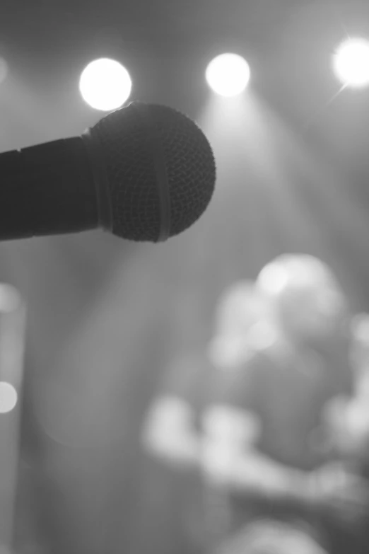 a close up of a microphone with bright lights in the background